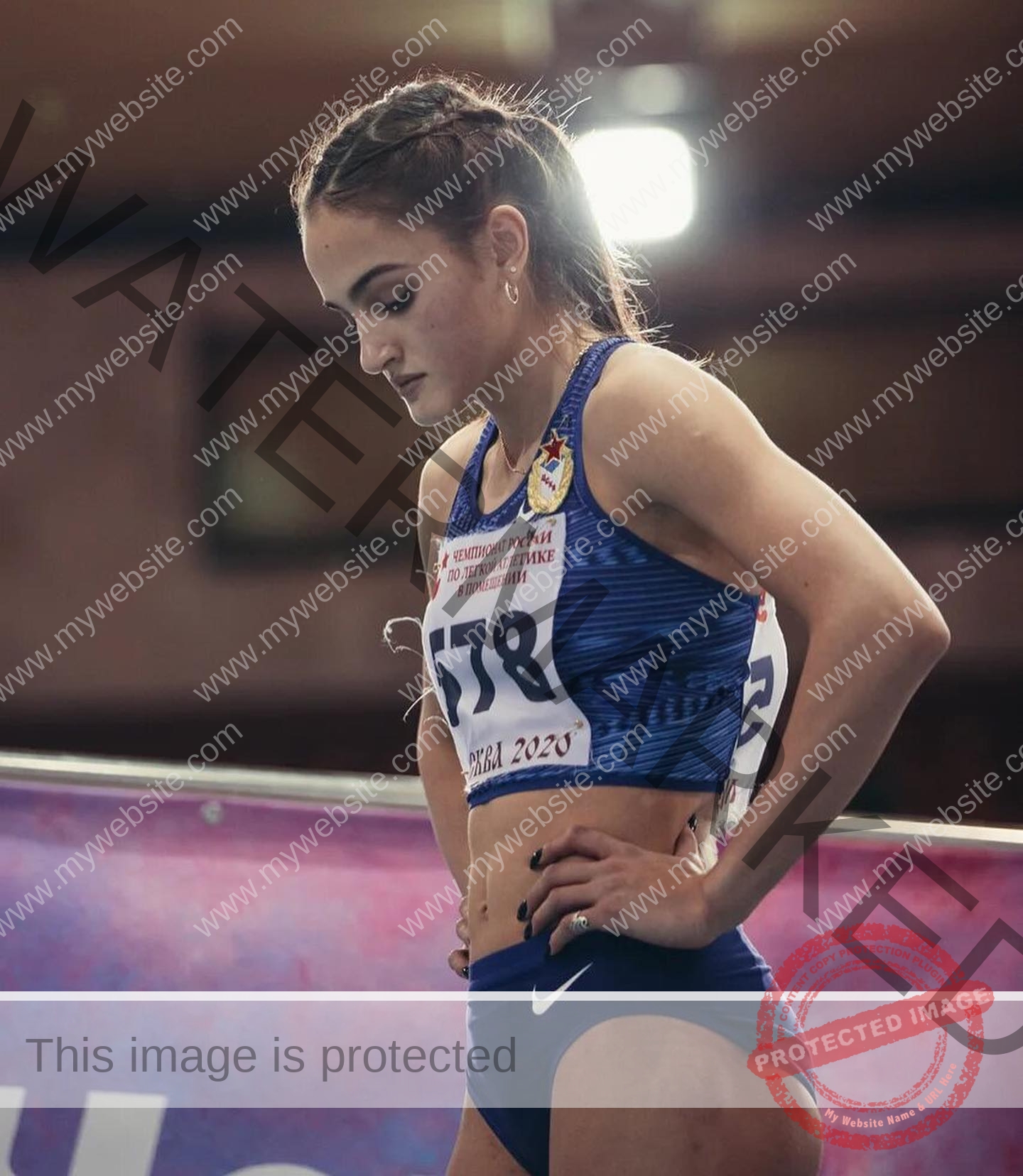 polina-tkalich-russia-p_a_tkalich-11513 Polina Tkalich, track and field star from Russia, stands in blue sportswear, race number 178 visible, focused before her indoor race.