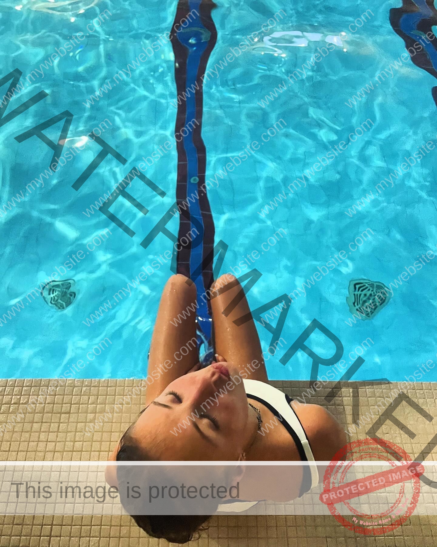 rufina-kotik-ukraine-rufina.kotik14-u18-01918 Rufina Kotik, track and field star from Ukraine, in a swimsuit sits on a pool edge, eyes closed, legs in blue water with lane lines.