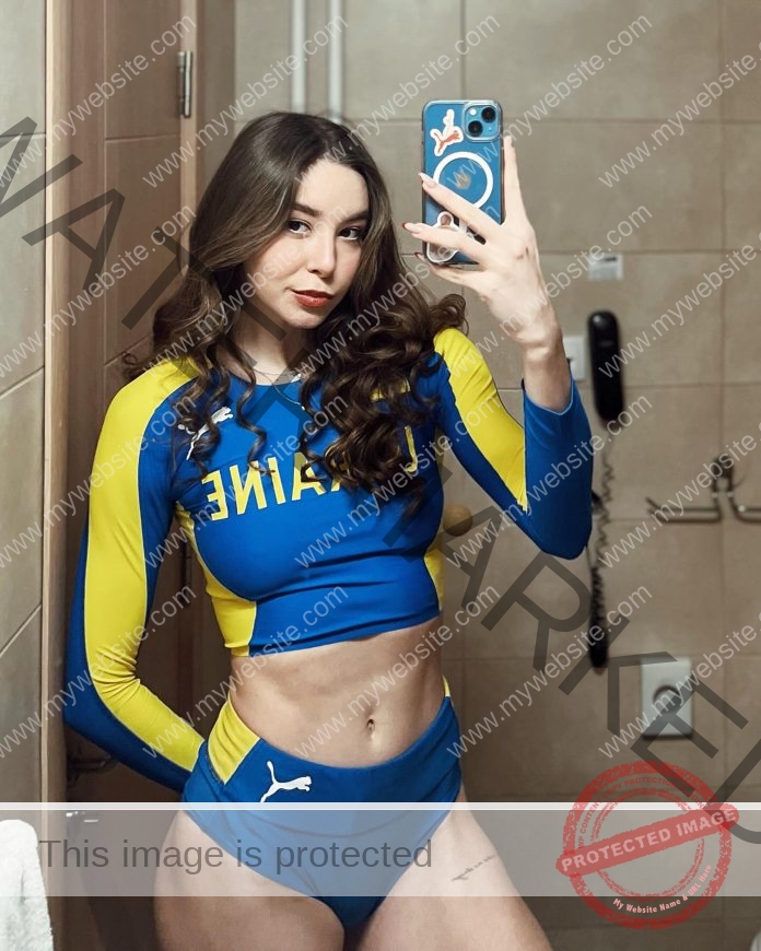 Svetlana Boichuk, track and field star from Ukraine, takes a mirror selfie in blue and yellow athletic wear marked UKRAINE.