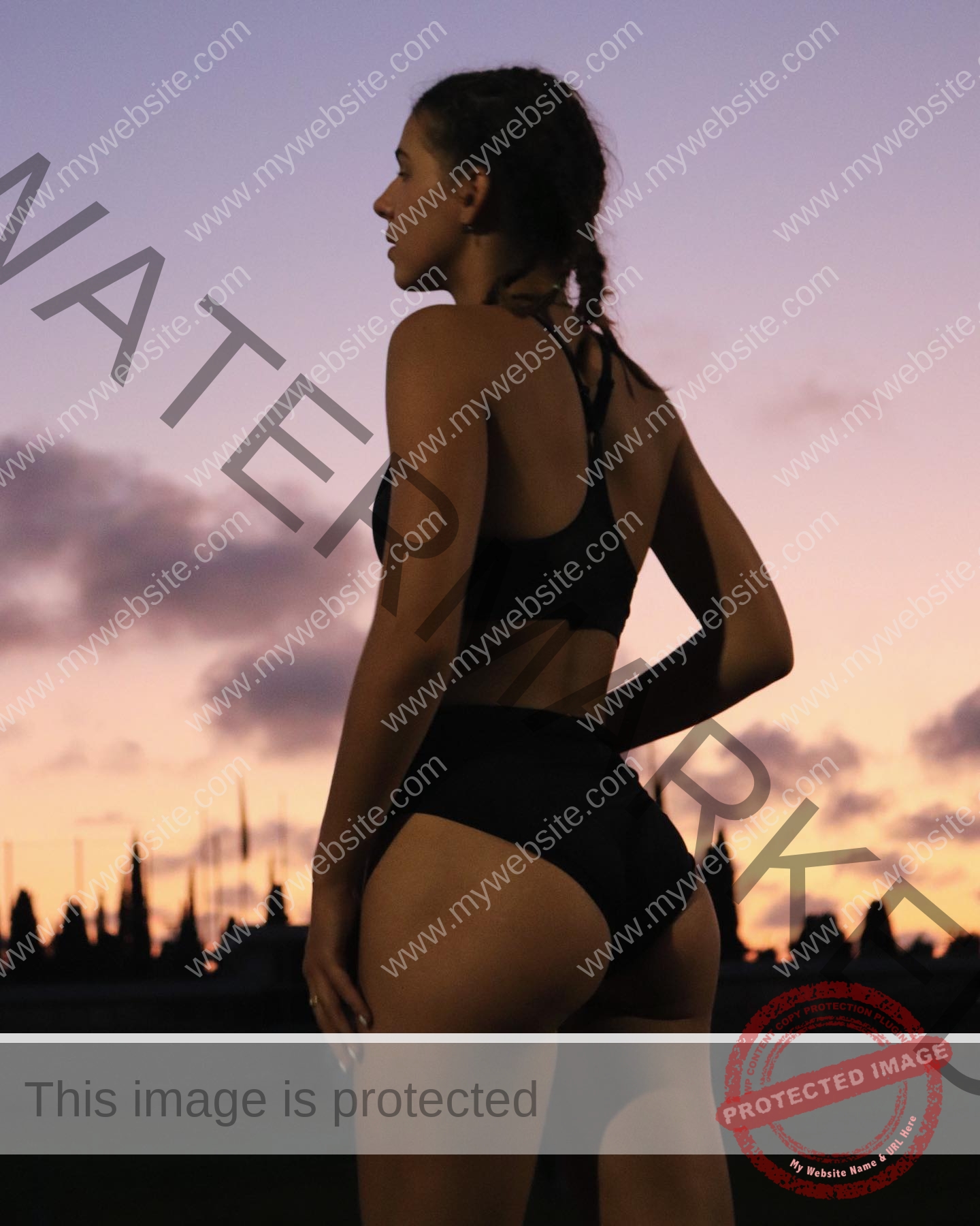 viktoriya-antipova-russia-viichkaaaaa-03526 Viktoriya Antipova, track and field star from Russia, stands outdoors at sunset in black sportswear, gazing sideways.