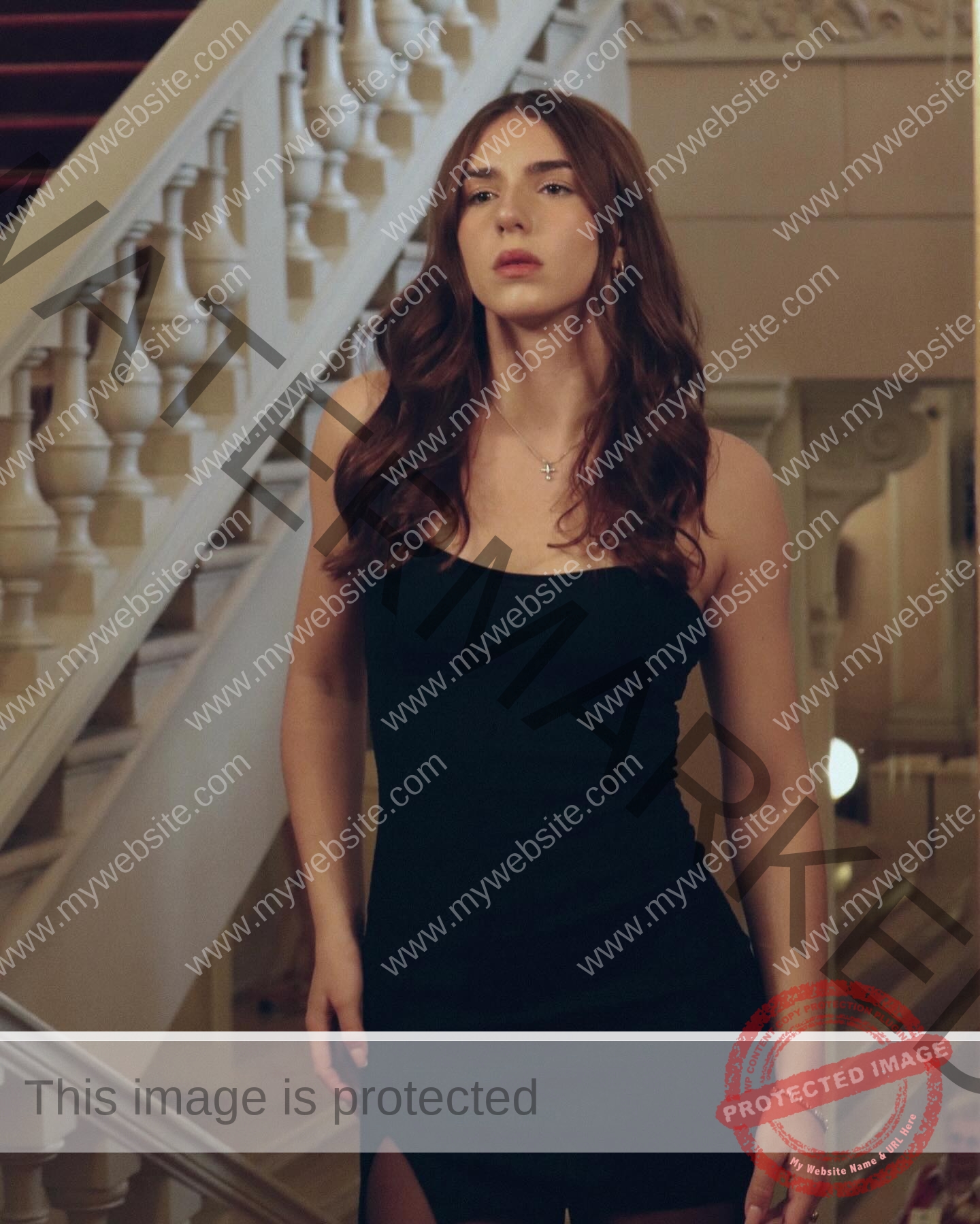 viktoriya-antipova-russia-viichkaaaaa-03642 Viktoriya Antapova, track and field star from Russia, with long brown hair in a black dress stands by an elegant white staircase.