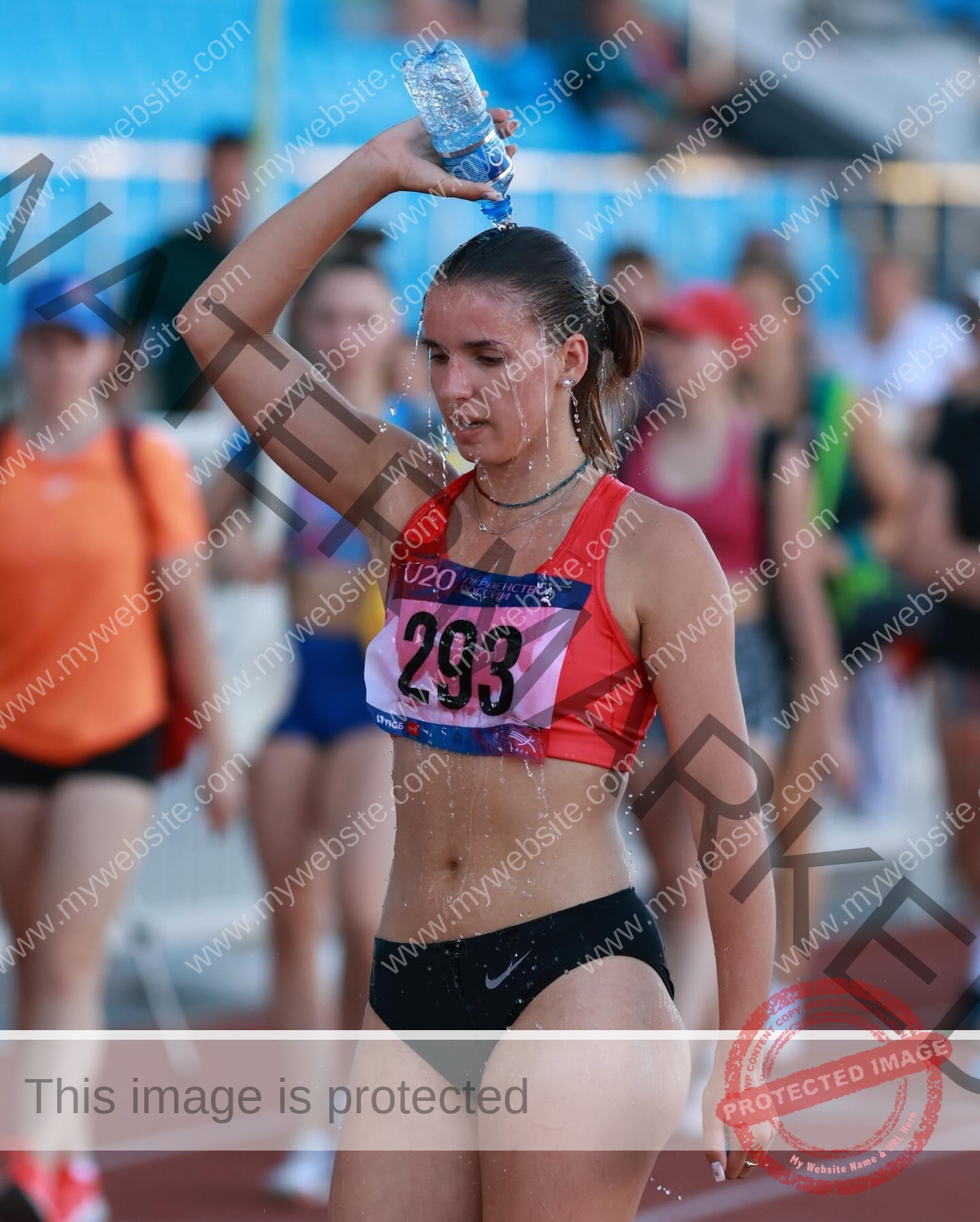 viktoriya-antipova-russia-viichkaaaaa-03648 Viktoriya Antapova, track and field star from Russia, pours water over her head in a red bra and black shorts, race number 293.