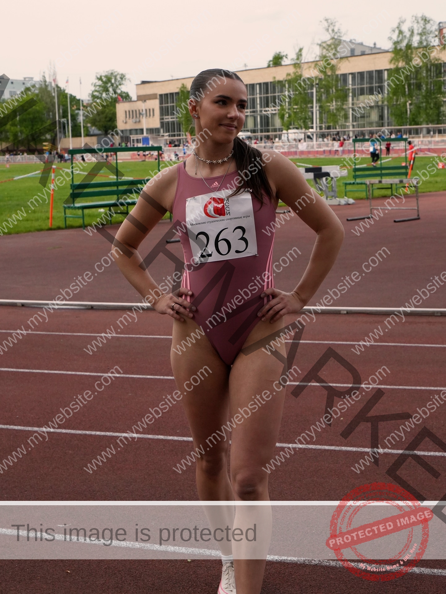 viktoriya-antipova-russia-viichkaaaaa-03730 Viktoriya Antipova, track and field star from Russia, stands confidently on the track in a mauve leotard with number 263.