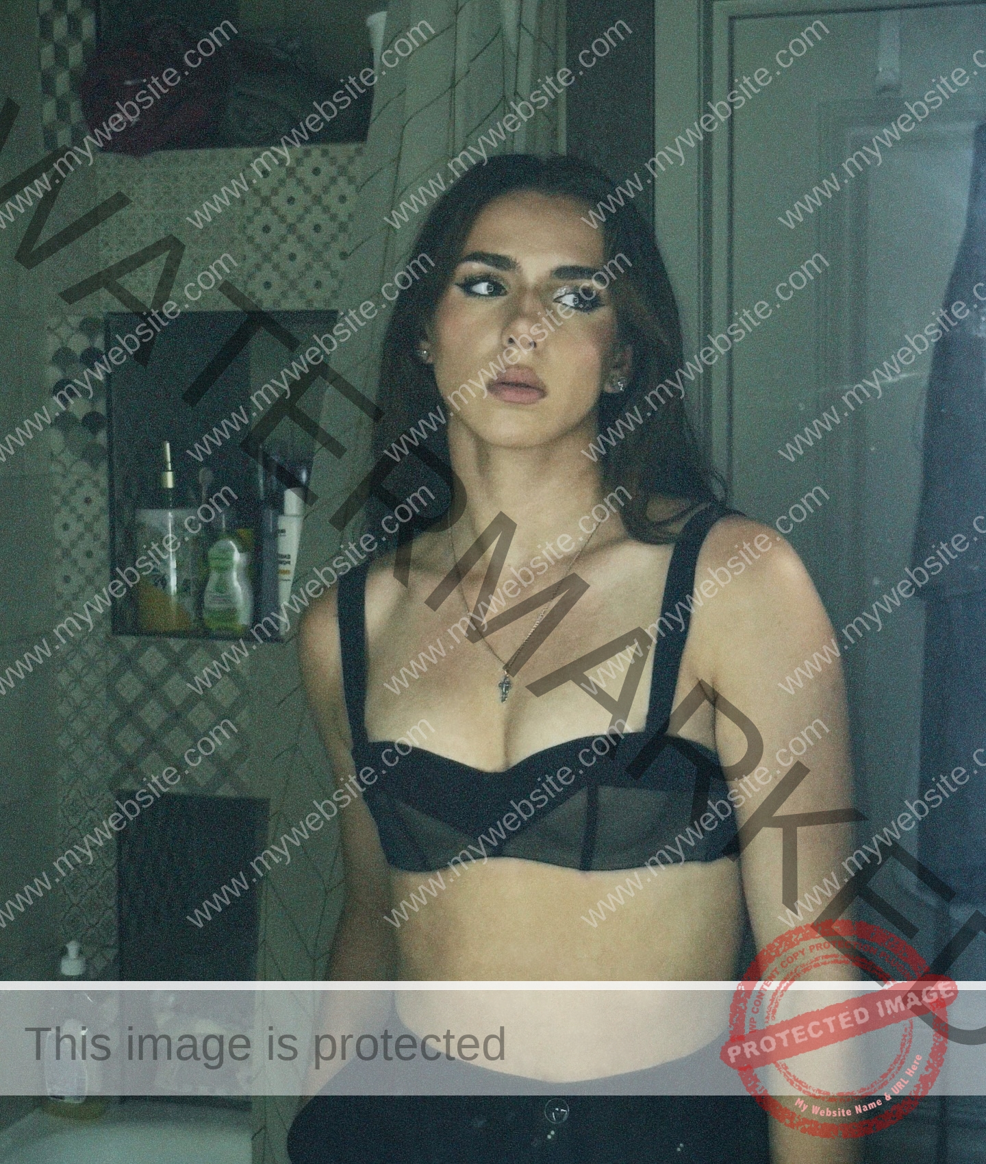 viktoriya-antipova-russia-viichkaaaaa-03737 Viktoriya Antapova, track and field star from Russia, stands in a bathroom in a black bralette, looking away; toiletries behind her.