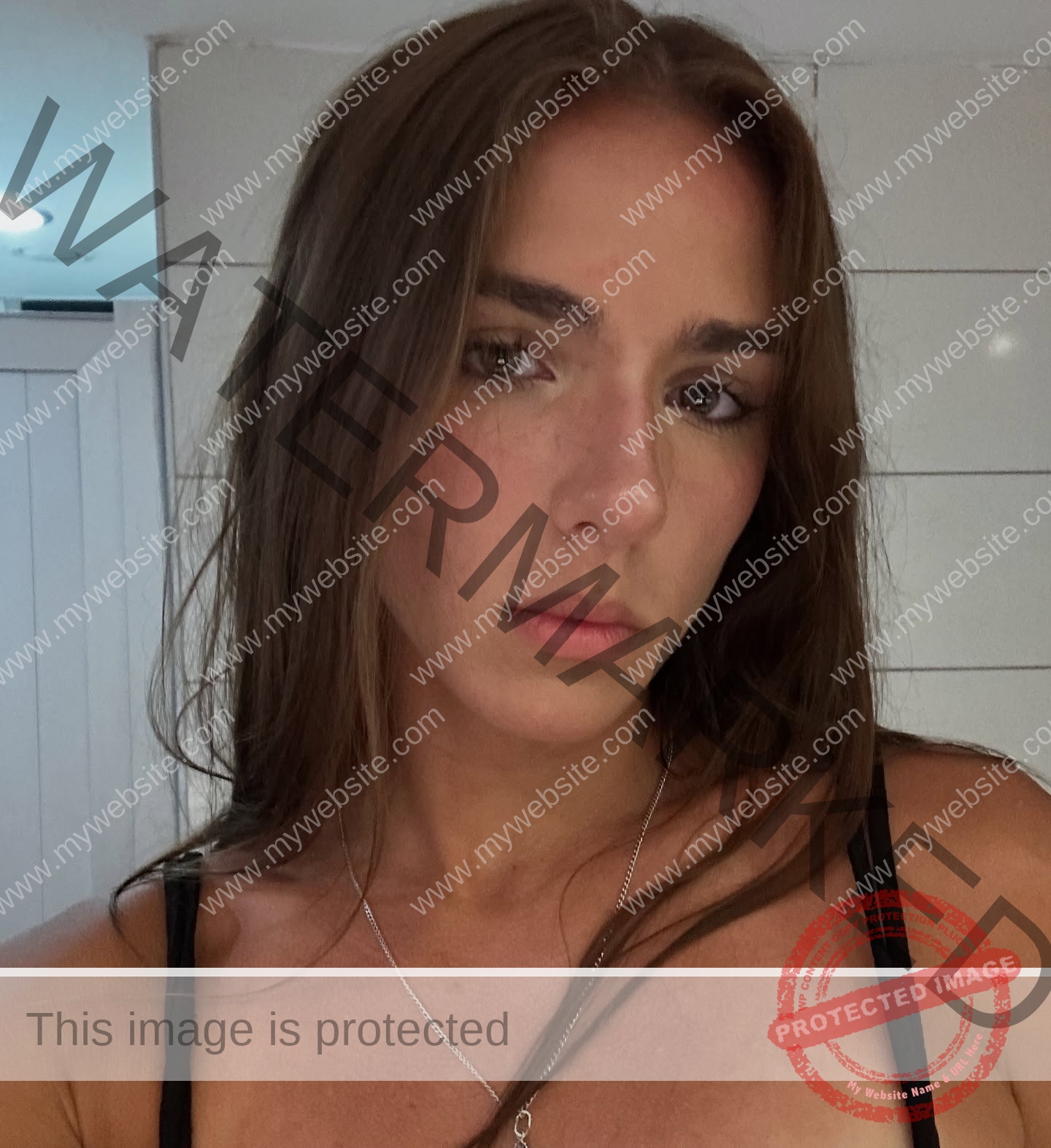 viktoriya-antipova-russia-viichkaaaaa-03757 Viktoriya Antapova, track and field star from Russia, with long brown hair and a neutral look, in black top and silver necklace.