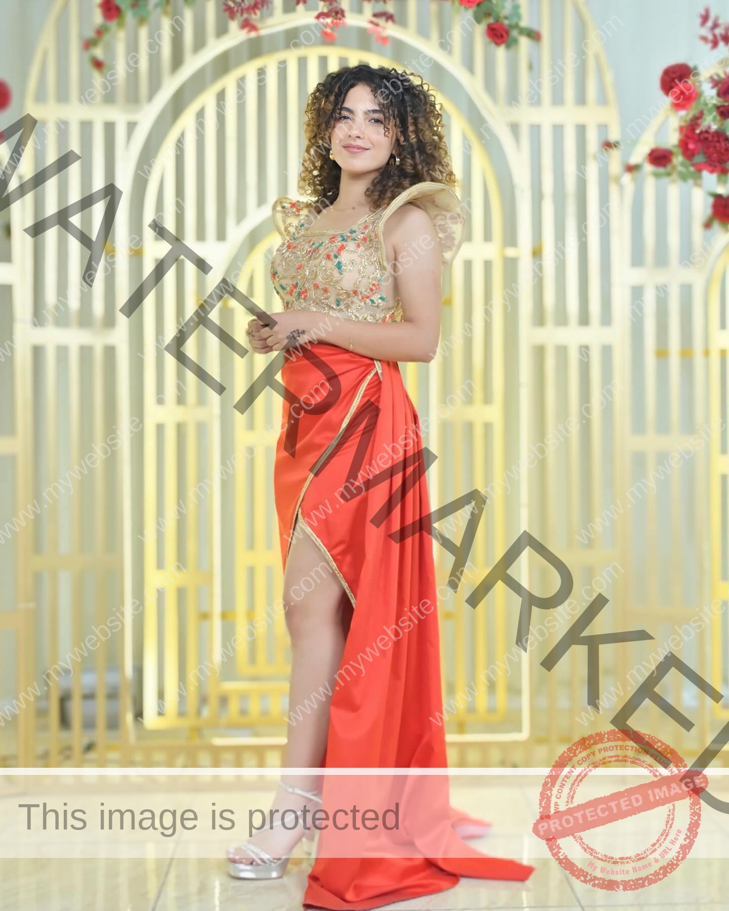 yassmine-baccar-tunisia-yassmine_baccar-08468 Yassmire Baccar, track and field star from Tunisia, poses confidently in front of gold decor in a floral top and red skirt.