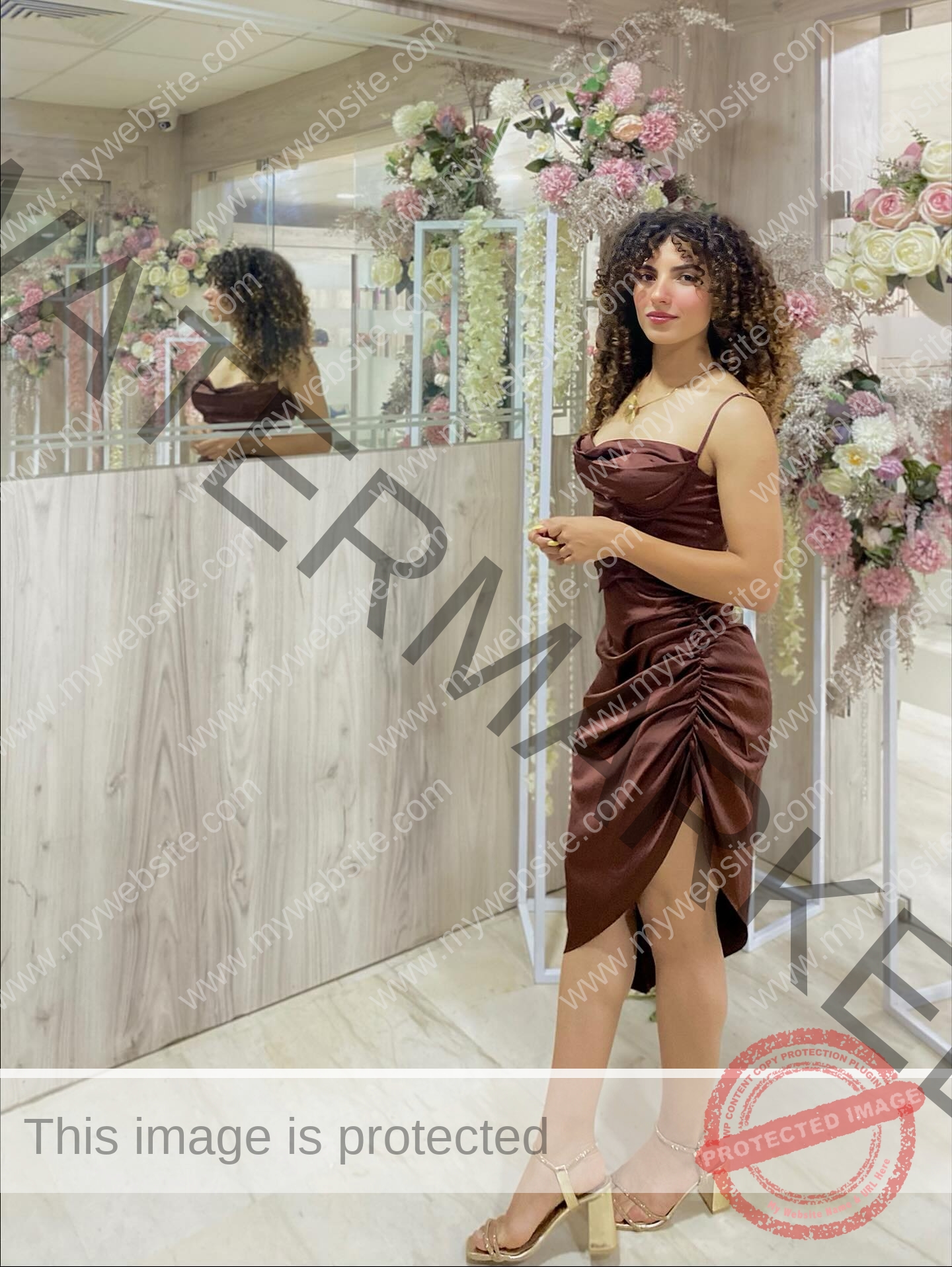 yassmine-baccar-tunisia-yassmine_baccar-08486 Yassmire Baccar, track and field star from Tunisia, in a brown satin dress and gold heels by a mirror amid pastel flowers.