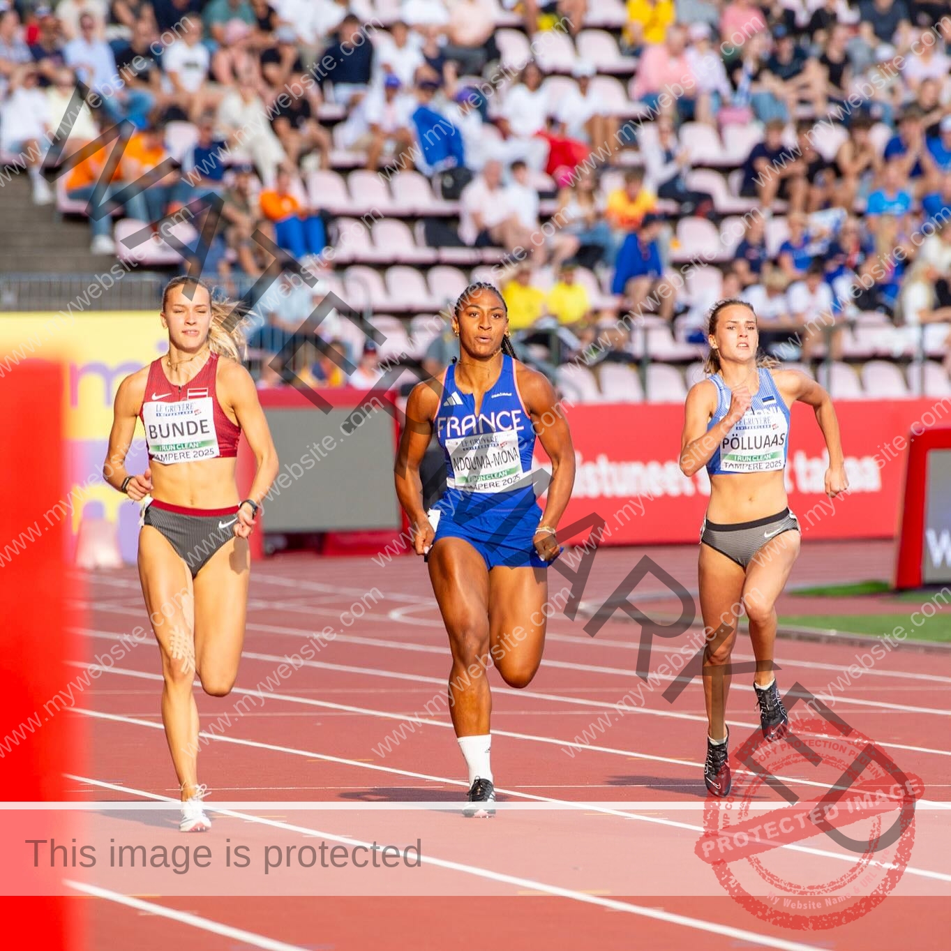 zola-ndouma-mona-france-zolaathle-09366 Zola Ndouma Mona, track and field star from France sprints with two athletes on a sunlit track, crowds watching in the background.
